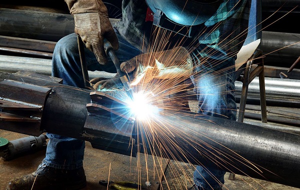 Image Of A Craftsman Welding A Stainless Steel Metal In A Steel Industry.